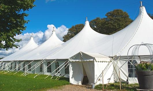 tall green portable restrooms assembled at a music festival, contributing to an organized and sanitary environment for guests in Carrier Mills